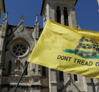 A "Don't Tread on me" flag is waved in front of San Fernando Cathedral during a Religious Freedom protest, Friday, March 23, 2012, in downtown San Antonio. Eric Gay/AP Photo. 