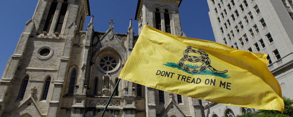 A "Don't Tread on me" flag is waved in front of San Fernando Cathedral during a Religious Freedom protest, Friday, March 23, 2012, in downtown San Antonio. Eric Gay/AP Photo. 