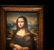 The copy of Leonardo da Vinci's famous Mona Lisa, painted on a panel around 1600, is displayed at the Artcurial auction house in Paris. Michel Euler/AP Photo.