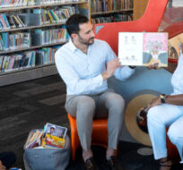 Ontario Education Minister Stephen Lecce and Patrice Barnes, Parliamentary Assistant to the Minister of Education read to children during a photo opportunity at an Etobicoke library, before a making a Government announcement, in Toronto, Sunday, April 16, 2023. Chris Young/The Canadian Press. 