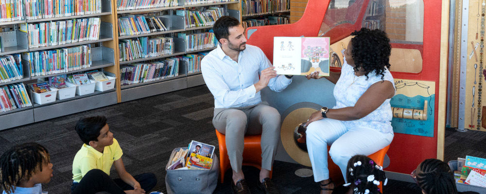 Ontario Education Minister Stephen Lecce and Patrice Barnes, Parliamentary Assistant to the Minister of Education read to children during a photo opportunity at an Etobicoke library, before a making a Government announcement, in Toronto, Sunday, April 16, 2023. Chris Young/The Canadian Press. 
