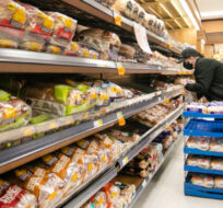 A worker restocks shelves in the bakery and bread aisle at an Atlantic Superstore grocery in Halifax, Friday, Jan. 28, 2022. Kelly Clark/The Canadian Press. 
