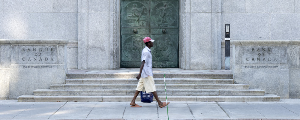 A man walks past the Bank of Canada building. Adrian Wyld/The Canadian Press.