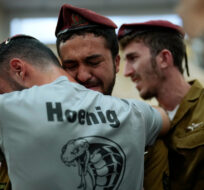 Mourners comfort each other during the funeral of Israeli soldier Benjamin Loeb, a dual Israeli-French citizen, in Jerusalem, Tuesday, Oct. 10, 2023. Francisco Seco/AP Photo. 