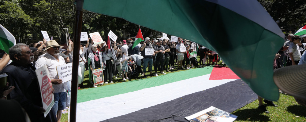 A large Palestinian flag is laid out as people gather in central Sydney for a rally on Oct. 15, 2023 to support Palestinians in Gaza. Rick Rycroft/AP Photo.