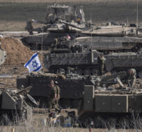 Israeli soldiers gather in a staging area near the border with Gaza Strip, in southern Israel on Oct. 15, 2023. Tsafrir Abayov/AP Photo.