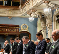 Members of the National Assembly stand in a minute of silence for the victims after a motion to condemn  the situation in Israel and Gaza, at the legislature in Quebec City, Tuesday, Oct. 17, 2023. Jacques Boissinot/The Canadian Press.