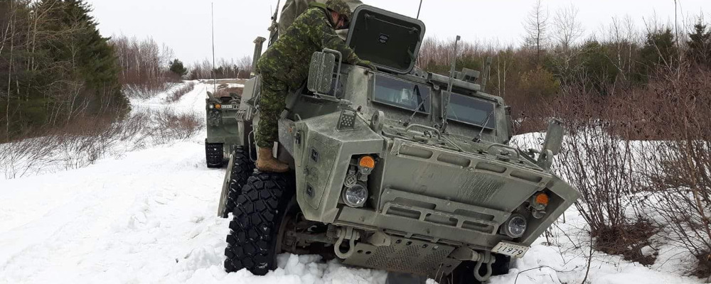 A Canadian Armed Forces vehicle stuck in the snow. Photo credit: Travis Rivard.