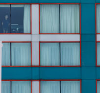 A guest looks out from a Sheraton hotel window in Mississauga, Ont. by the Pearson International Airport on Monday, Feb. 22, 2021 as new air travel rules come into effect in Canada. Cole Burston/The Canadian Press. 
