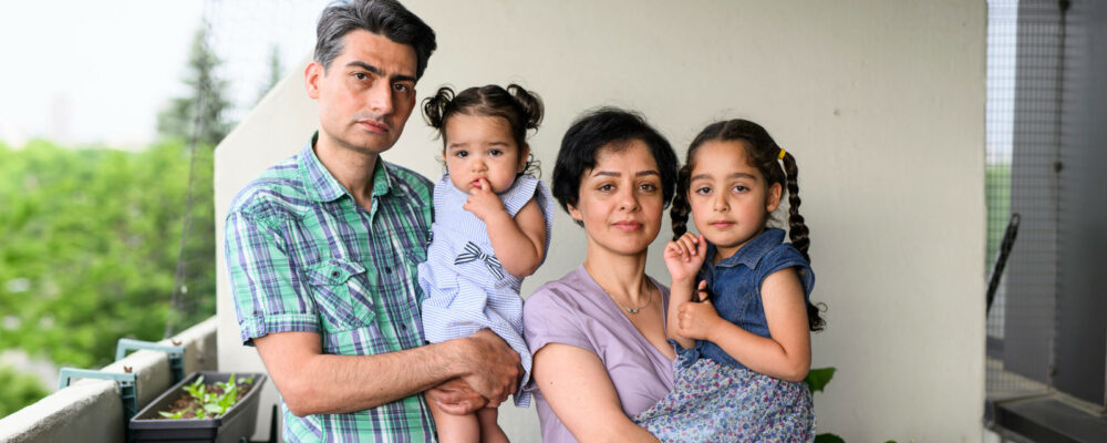 Hamid Ahmadpanah, left, and Shohreh Aghababaei, second from right, stand with their daughters Kyla, 15 months, and Amelia, 5, at their home in Ottawa, on Thursday, June 8, 2023. Justin Tang/The Canadian Press. 