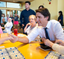 Prime Minister Justin Trudeau sits with a group of seniors between Bingo games during a visit to Sackville Hill Senior Recreation Centre in Hamilton, Ont., Monday, July 31, 2023. Peter Power/The Canadian Press. 