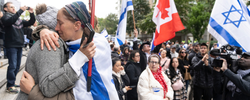 Talia Ben Sasson, right, hugs Ayellet Tzur as they attend a rally in support of Israel in Montreal, Tuesday, Oct. 10, 2023. Christinne Muschi/The Canadian Press. 