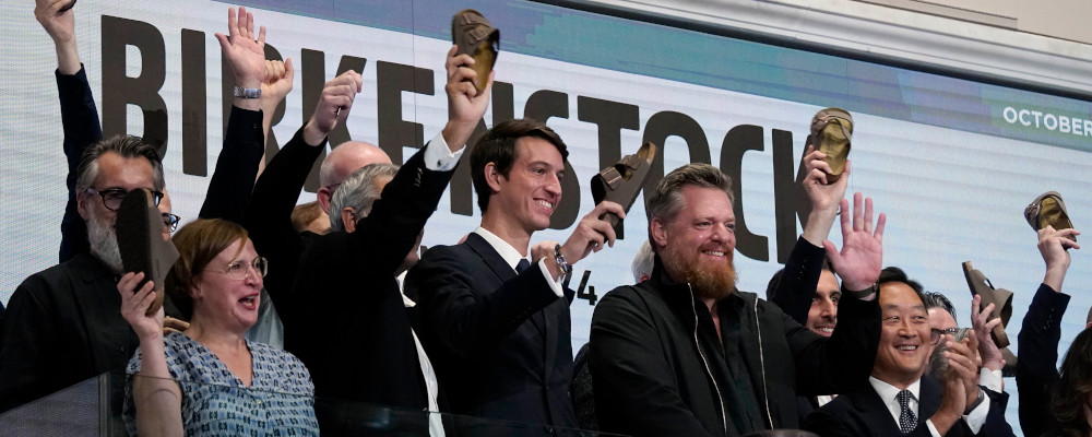 Birkenstock CEO Oliver Reichert, second from right, waves as he rings the New York Stock Exchange opening bell, prior to his company's IPO, Wednesday, Oct. 11, 2023. Richard Drew/AP Photo. 