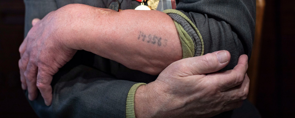 In this photo taken on Monday, Jan. 20, 2020, Yevgeny Kovalyov, 92, one of the Auschwitz concentration camp's survivors, shows the camp's identification number tattooed on his arm during an interview with the Associated Press at his flat in Moscow, Russia. Alexander Zemlianichenko/AP Photo. 
