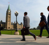 People make their way to the centre block as the House of Commons returns following the summer break on Parliament Hill in Ottawa on Monday, Sept. 18, 2017. Sean Kilpatrick/The Canadian Press. 