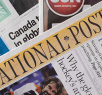 Postmedia newspapers, including the National Post and Ottawa Citizen, are shown with Quebecor Media's Ottawa Sun on Monday, Oct. 6, 2014. Justin Tang/The Canadian Press.