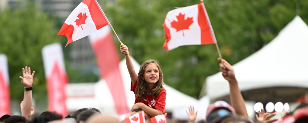 A child waves the Maple Leaf flag during Canada Day celebrations at LeBreton Flats in Ottawa, on Friday, July 1, 2022. Justin Tang/The Canadian Press. 