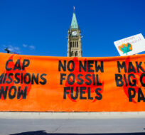 People participate in a climate protest on Parliament Hill in Ottawa on Friday, Sept. 15, 2023. Sean Kilpatrick/The Canadian Press. 