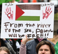 A person holds up a sign during a pro-Palestine rally in Montreal, Sunday, November 12, 2023. Graham Hughes/The Canadian Press. 