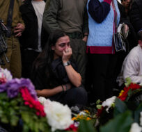Family and friends of Israeli soldier Major Roei Meldasi mourn over his grave during his funeral in Afula, Israel, Wednesday, Dec. 13, 2023. Ariel Schalit/AP Photo. 