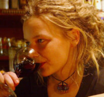 A young woman drinks a glass of wine in a bar in downtown Prague, Czech Republic, Dec. 10, 2004. Petr David Josek/AP Photo.
