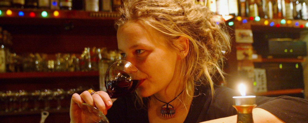 A young woman drinks a glass of wine in a bar in downtown Prague, Czech Republic, Dec. 10, 2004. Petr David Josek/AP Photo.