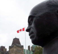 A statue of former prime minister William Lyon Mackenzie King looks over the Parliament buildings Friday, September 13, 2013 in Ottawa. Adrian Wyld/The Canadian Press.