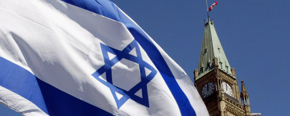 The Israeli flag flies with the Peace Tower in the background in Ottawa Sunday, April 21, 2002. Jonathan Hayward/CP Photo. 