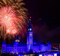 Fireworks explode above the Peace Tower and Centre Block during Canada Day celebrations on Parliament Hill in Ottawa on Monday, July 1, 2019. Justin Tang/The Canadian Press. 
