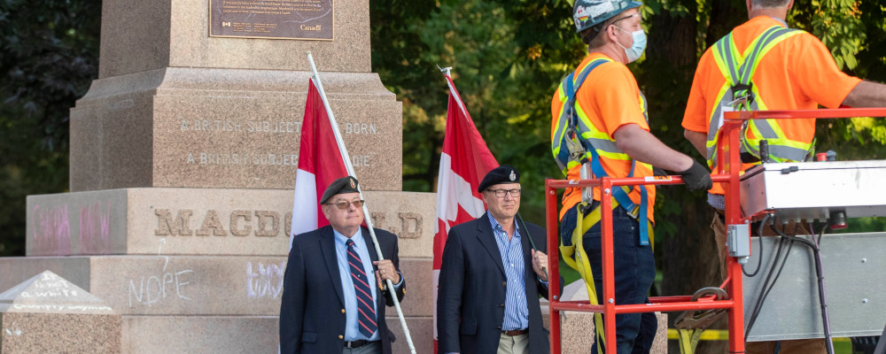 Veterans protest before the removal of a statue Sir John A. Macdonald in Kingston, Ontario on Friday June 18, 2021.  Lars Hagberg/The Canadian Press. 