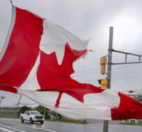 A Canadian flag waves in the high winds in Dartmouth, N.S. on Saturday, Sept. 24, 2022. Andrew Vaughan/The Canadian Press.