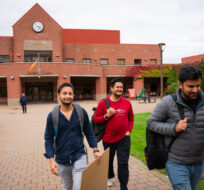 Cape Breton University students, from left, Sourabh Sharma, Parminder Singh and Manpreet Kalra leave through the campus courtyard in Sydney, N.S., Wednesday, Oct. 18, 2023. THE Steve Wadden/CANADIAN PRESS