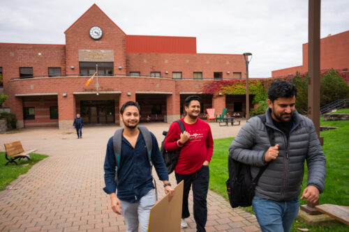 Cape Breton University students, from left, Sourabh Sharma, Parminder Singh and Manpreet Kalra leave through the campus courtyard in Sydney, N.S., Wednesday, Oct. 18, 2023. THE Steve Wadden/CANADIAN PRESS