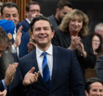 Conservative leader Pierre Poilievre smiles as he is applauded during Question Period, Wednesday, November 29, 2023 in Ottawa. Adrian Wyld/The Canadian Press.