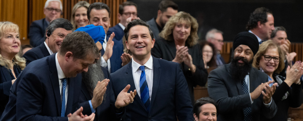Conservative leader Pierre Poilievre smiles as he is applauded during Question Period, Wednesday, November 29, 2023 in Ottawa. Adrian Wyld/The Canadian Press.
