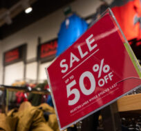 A sale sign advertising up to 50 per cent off in a store at the McArthurGlen Designer Outlet on Boxing Day in Richmond, B.C., on Tuesday, December 26, 2023. Ethan Cairns/The Canadian Press.