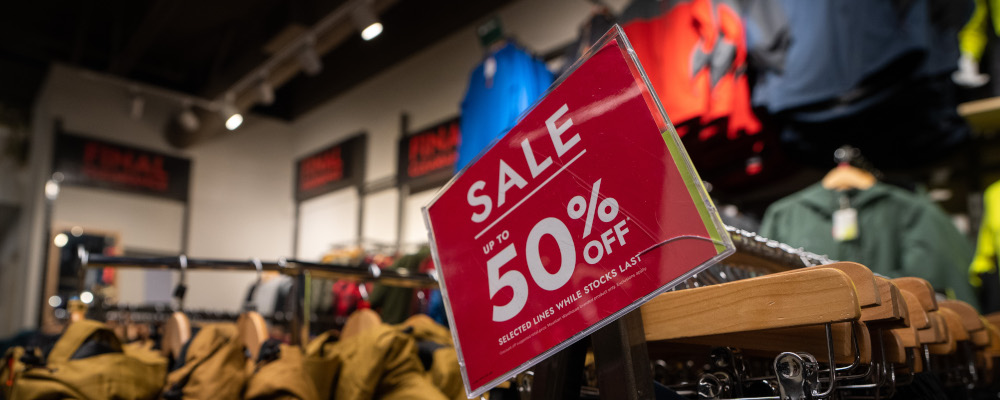A sale sign advertising up to 50 per cent off in a store at the McArthurGlen Designer Outlet on Boxing Day in Richmond, B.C., on Tuesday, December 26, 2023. Ethan Cairns/The Canadian Press.