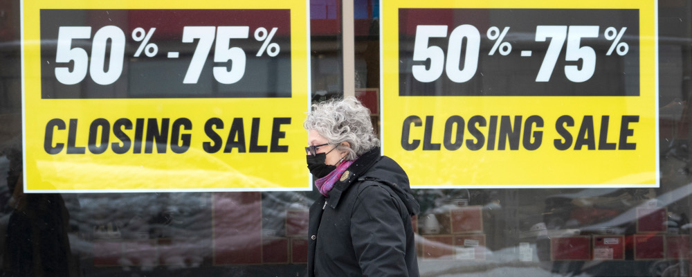 A pedestrian walks past a store advertising a going out of business sale, Thursday, January 13, 2022  in Montreal. Ryan Remiorz/The Canadian Press. 