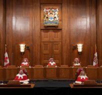 Justices of the Supreme Court pose for a photo sitting in the Supreme Court following a welcoming ceremony, Thursday, October 28, 2021 in Ottawa.  THE Adrian Wyld/Canadian Press