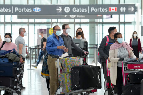 People wait in line to check in at Pearson International Airport in Toronto on Thursday, May 12, 2022. Nathan Denette/The Canadian Press.