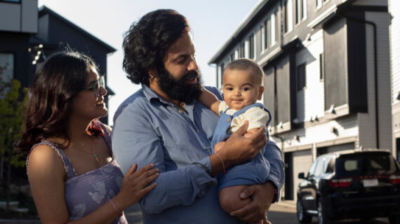 Zeel Shah with her husband Deep Cheema and their son Rehaan Cheema, pose for a photo outside of their home in Edmonton on Friday, October 7, 2022. Amber Bracken/The Canadian Press. 
