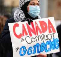 People protest in front of Parliament Hill in Ottawa on Wednesday, Nov. 8, 2023. Sean Kilpatrick/The Canadian Press. 