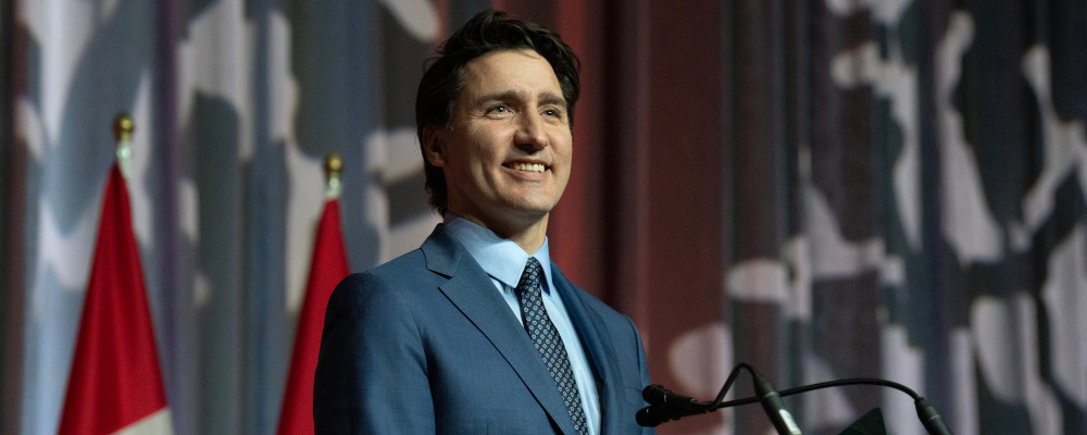 Prime Minister Justin Trudeau smiles as he is applauded at the National Caucus holiday party, Tuesday, December 12, 2023 in Ottawa.  Adrian Wyld/The Canadian Press. 