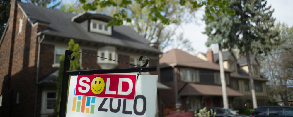A sold sign is shown in front of west-end Toronto homes Sunday, May 14, 2017. Graeme Roy/The Canadian Press. 