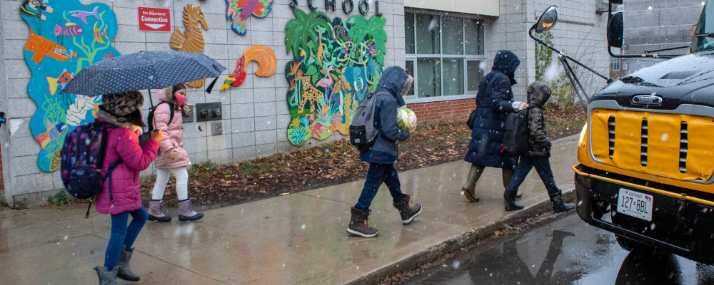 Students from board a bus outside Thorncliffe Park Public School in Toronto on Friday December 4, 2020. Frank Gunn/The Canadian Press. 