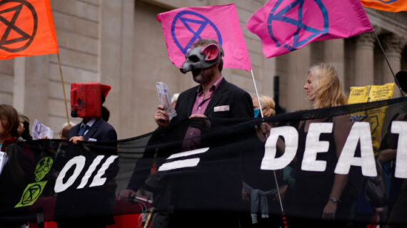 Extinction Rebellion climate change activists hold a banner during a protest backdropped by the Bank of England, in the City of London financial district in London, Thursday, Sept. 2, 2021. Matt Dunham/AP Photo. 