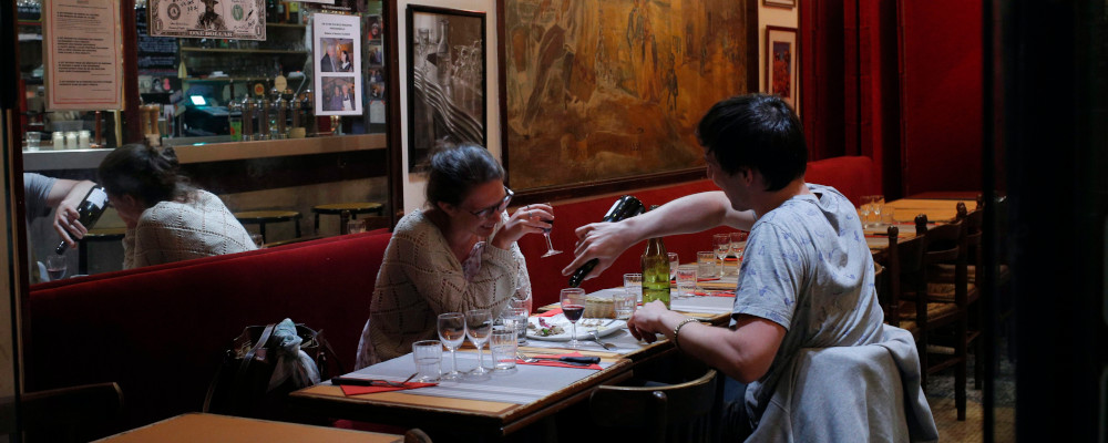 In this photo taken on Monday, June 25, 2018, a couple attend a romantic diner at a restaurant in Montmartre district, in Paris. Francois Mori/AP Photo. 