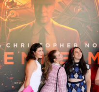 From left, Gabrielle Roitman, Kayla Seffing, Maddy Hiller and Casey Myer take a selfie in front of an "Oppenheimer" movie poster before they attended an advance screening of "Barbie," Thursday, July 20, 2023, at AMC. Chris Pizzello/AP Photo. 