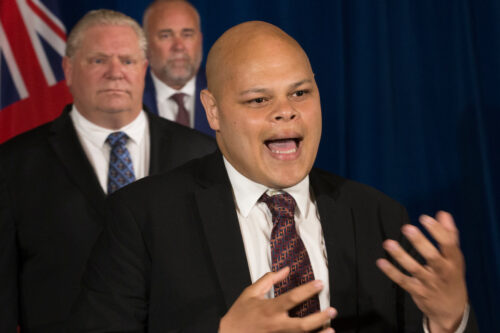 Jamil Jivani speaks as Ontario Premier Doug Ford, left, and Minister of Children, Community and Social Services Todd Smith listens on during a briefing in Toronto on Thursday, June 4, 2020. Rick Madonik/The Canadian Press. 
