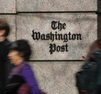 In this Thursday, Feb. 21, 2019, file photo, people walk by the One Franklin Square Building, home of The Washington Post newspaper, in downtown Washington. Pablo Martinez Monsivais/AP Photo. 